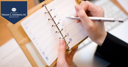 Person with calendar notebook and pen.