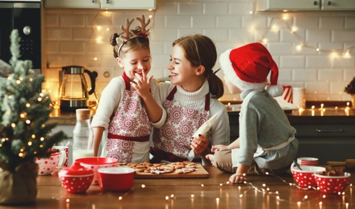 Kids with parent in kitchen baking.