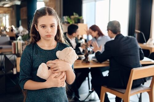 Girl holding a teddy bear during a CPS investigation